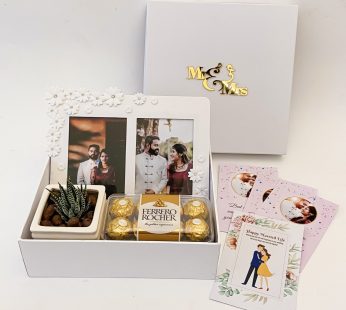 Order best marriage gifts for friends At your lowest Cost this gift  hamper with the Plant , Frame and more with blissful greetings!