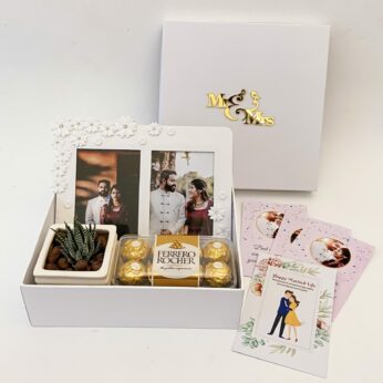 Order best marriage gifts for friends At your lowest Cost this gift  hamper with the Plant , Frame and more with blissful greetings!