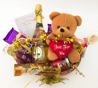 Delightful Anniversary hamper with a Teddy Bear, Wine and blissful greetings