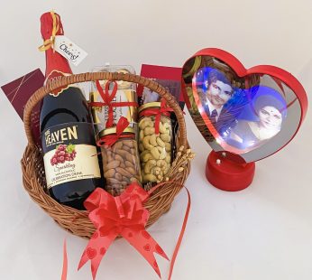 Delightful anniversary gift hamper with a Wine , Chocolate and blissful greetings