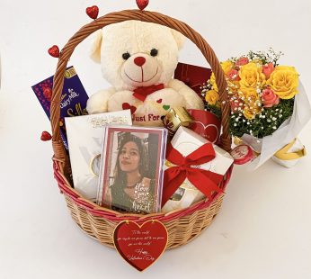 Enchanting happy Valentines Day gift basket with premium chocolates, photo frame, fresh flower bouquet and more