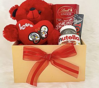 Alluring valentine’s day gift hampers with elegant teddy, chocolates, Nutella, toblerone, and cards