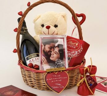 Lovely Romantic gift for wife adorned with soft teddy, wine, photo frame, & cards