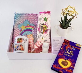 graceful birthday gift for kid girl in India with chocolates, a plant, and greetings