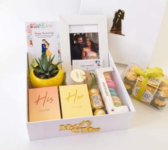 Fabulous wedding hampers for couples adorned with Photo frames, macarons, and chocolates