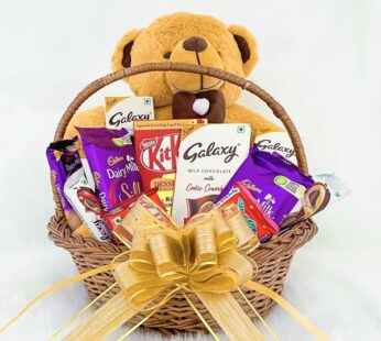 Blissful gift hamper basket for her contains a teddy bear and delicious chocolates.