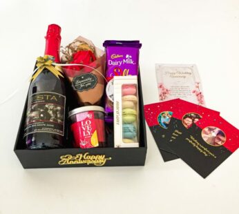 A beautiful Anniversary gift pack for couple with chocolates, grape juice, and more
