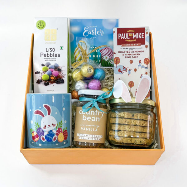 An Easter hampers box with a bright yellow color. The box is rectangular and has a glossy finish. It is filled with an assortment of Easter treats and decorations
