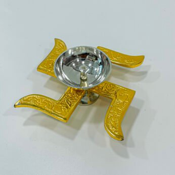 Alluring golden brass puja lamp with swastika symbol (H 1.75 x W 6 x L 1.25 inches)